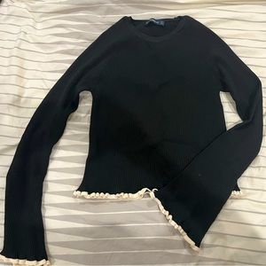 Black knit sweater with white trim